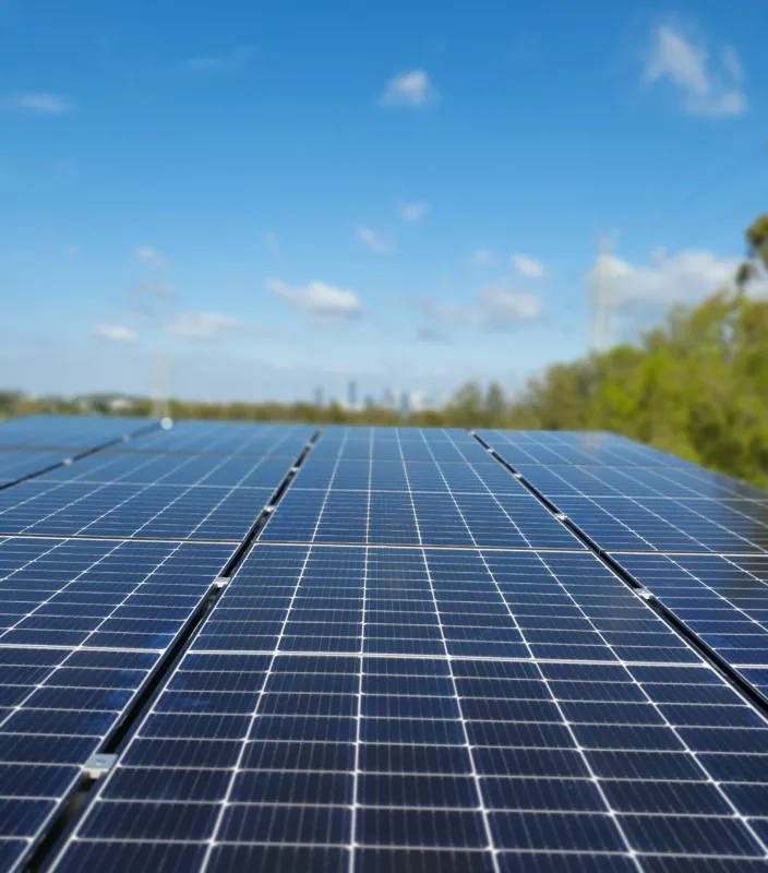Solar panels under a blue sky, generating clean energy.