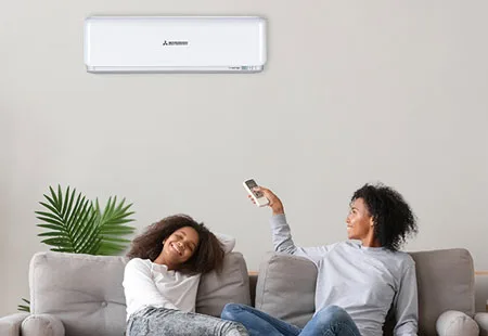 Mitsubishi mini-split AC: Mother and daughter relaxing on sofa