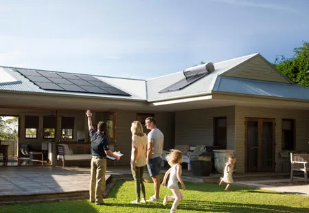 Photographer using a DSLR camera to capture a sunset over mountains. Landscape photography.