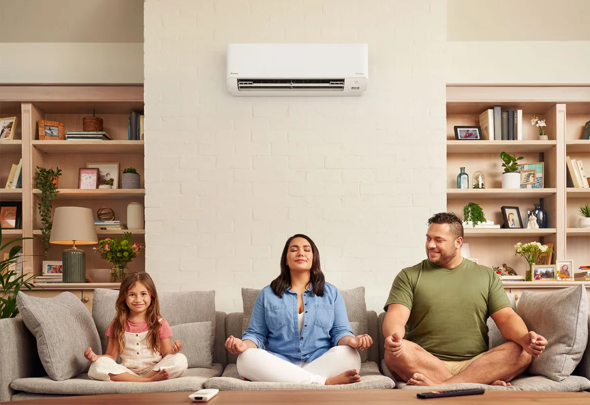Family meditating peacefully under an air conditioner. Serene home climate control.