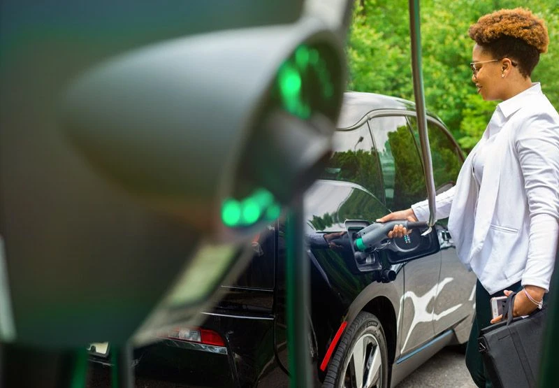 What are EV Chargers? Image of person charging their vehicle. 